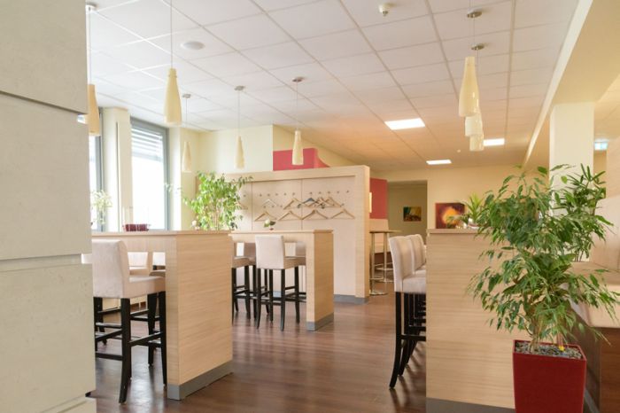 Blick in den Cafe & Lounge Bereich sowie Garderobe und Eingangszone von qSkills, ohne Teilnehmende
