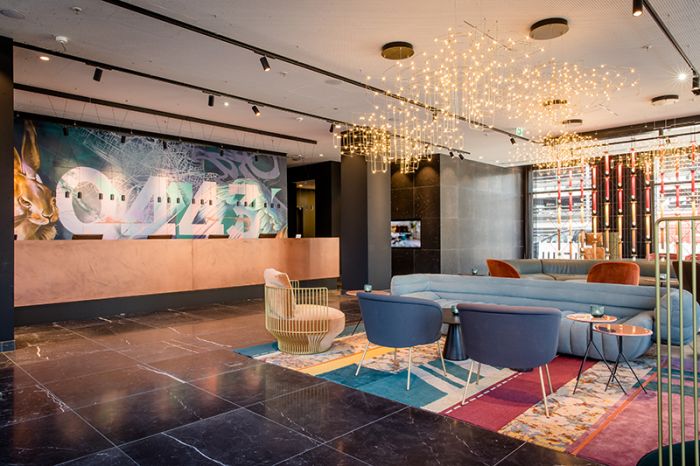Reception area of the Motel One hotel at Nuremberg Central Station with a modern lobby design