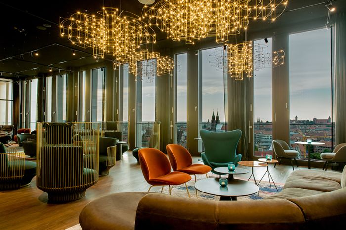 Interior view of the seating area in the Roof Bar at the Motel One hotel at Nuremberg Central Station, with a view over the city center.